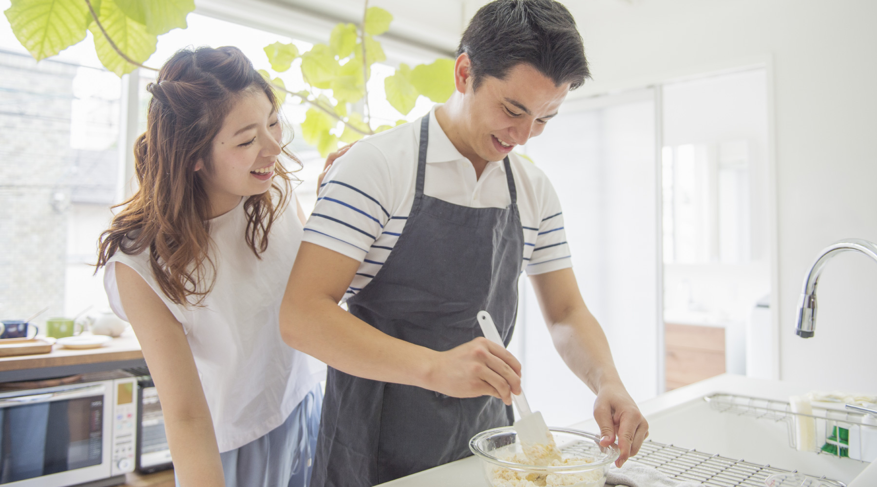 Young couple smiling and cooking