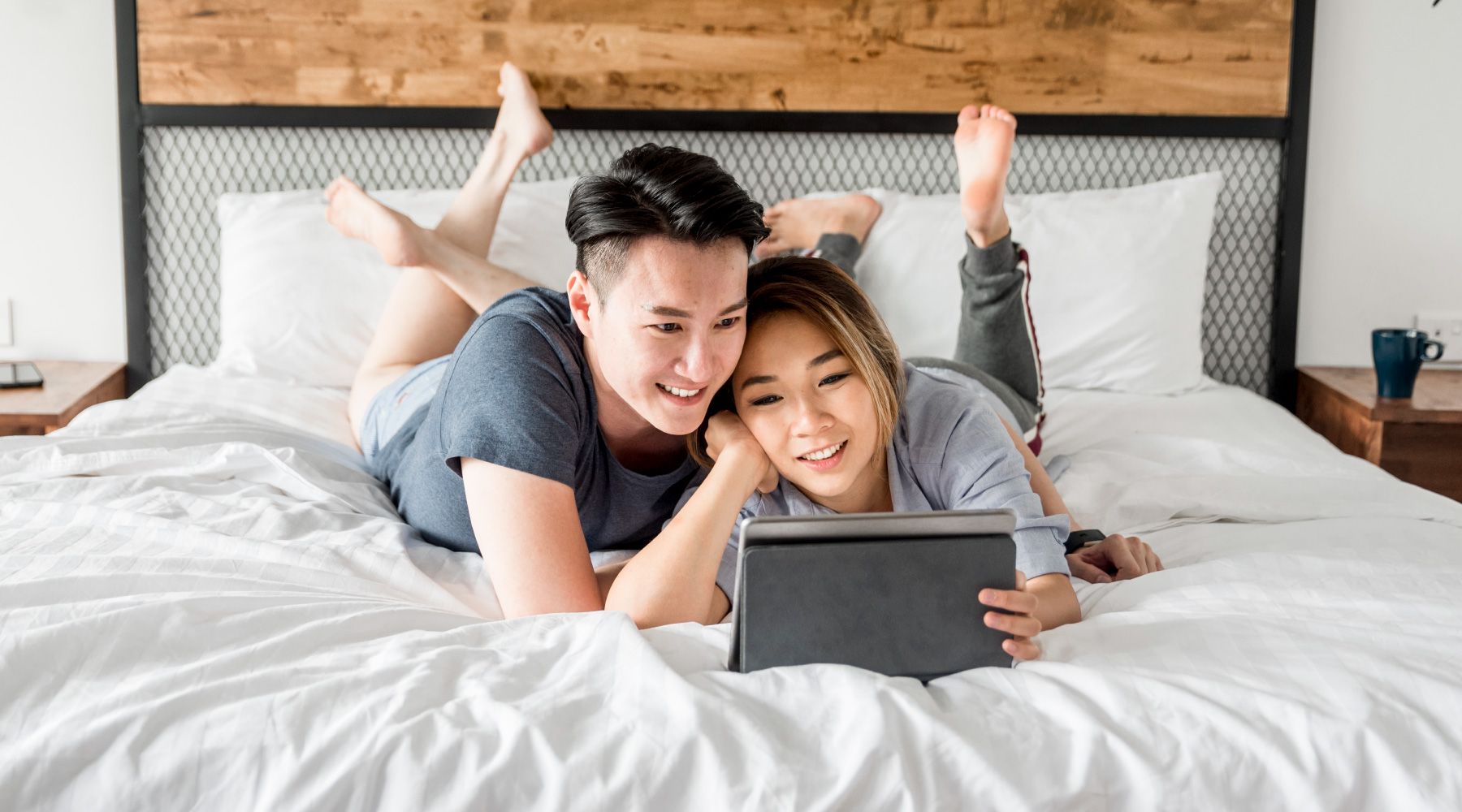 Couple at home looking at tablet